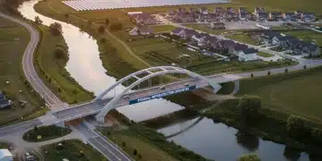 Rural Development Grants 2026: Federal Funding Opportunities for Community Infrastructure Modern rural infrastructure with solar panels and a new bridge at sunset, symbolizing federal funding success.